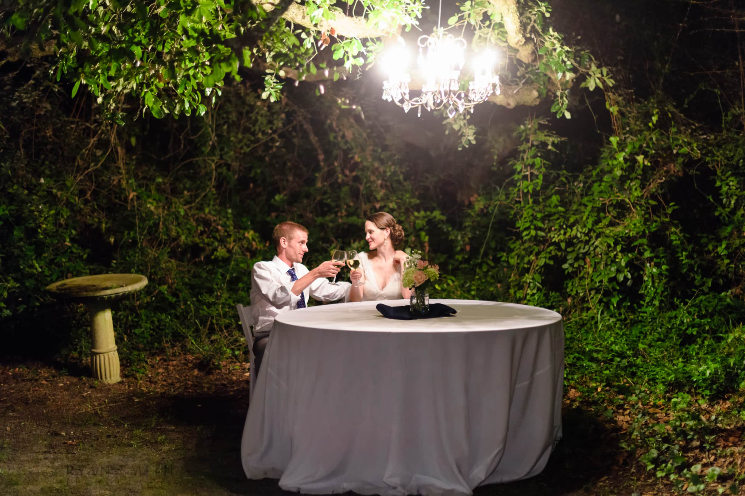 Couple sitting outdoors under chandelier  - Pelican Inn, Pawleys Island