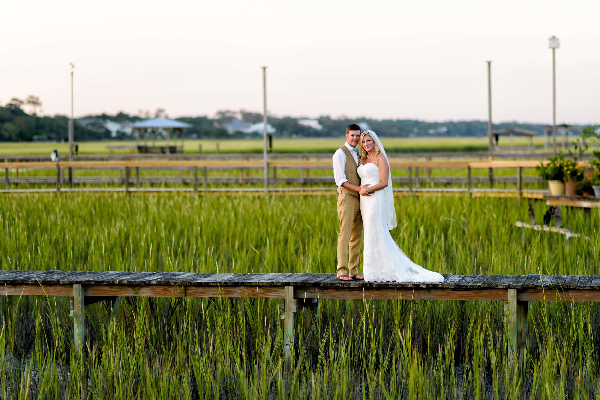 Couple standing together on a marsh walkway - Pawleys Island