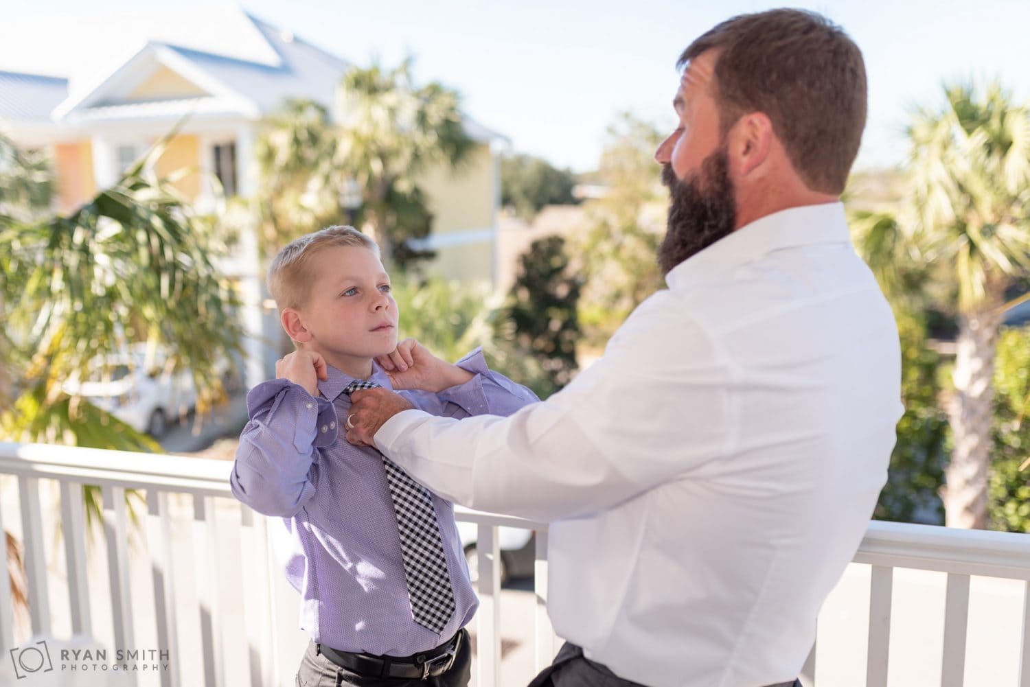 Dad putting on his son's tie 21 Main Events at North Beach