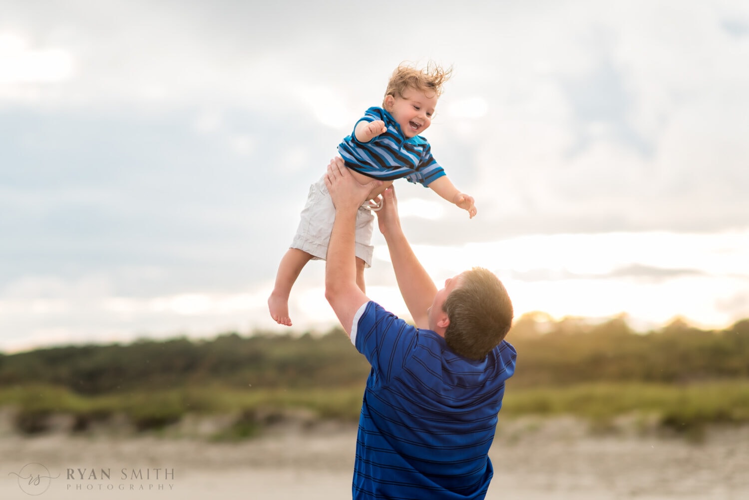 Dad throwing son into the air - Myrtle Beach