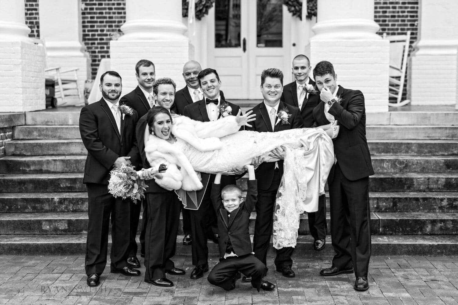 Groom and groomsmen having fun lifting up the bride - Rosewood Manor, Marion