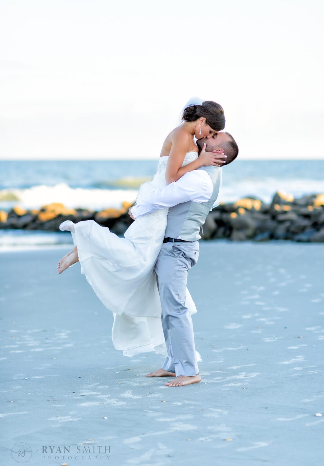 Groom lifting bride off the ground for a kiss - Murrells Inlet