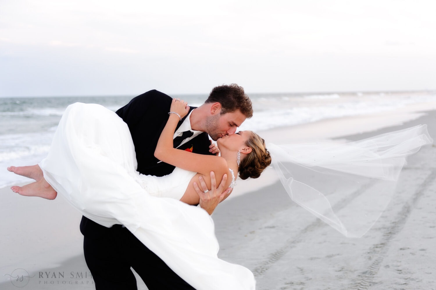 Groom picking up bride and giving her a kiss - Ocean Club, Grande Dunes, Myrtle Beach