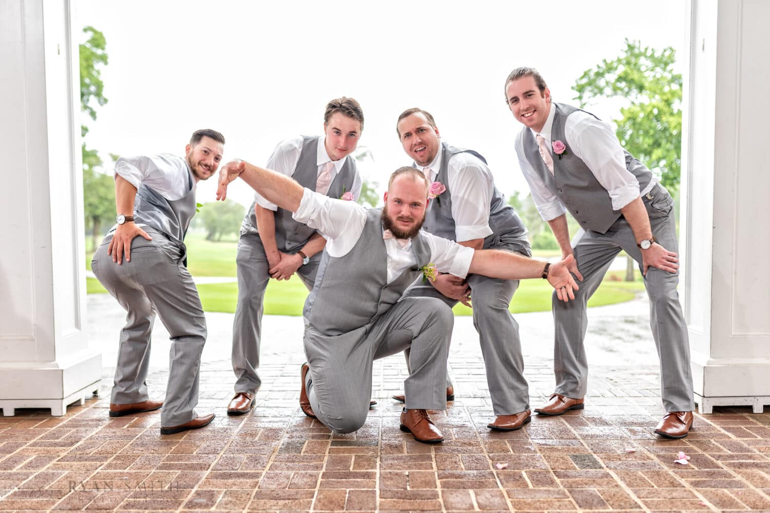 Groomsmen having fun on a rainy day - using off camera flash helps with the bright background -