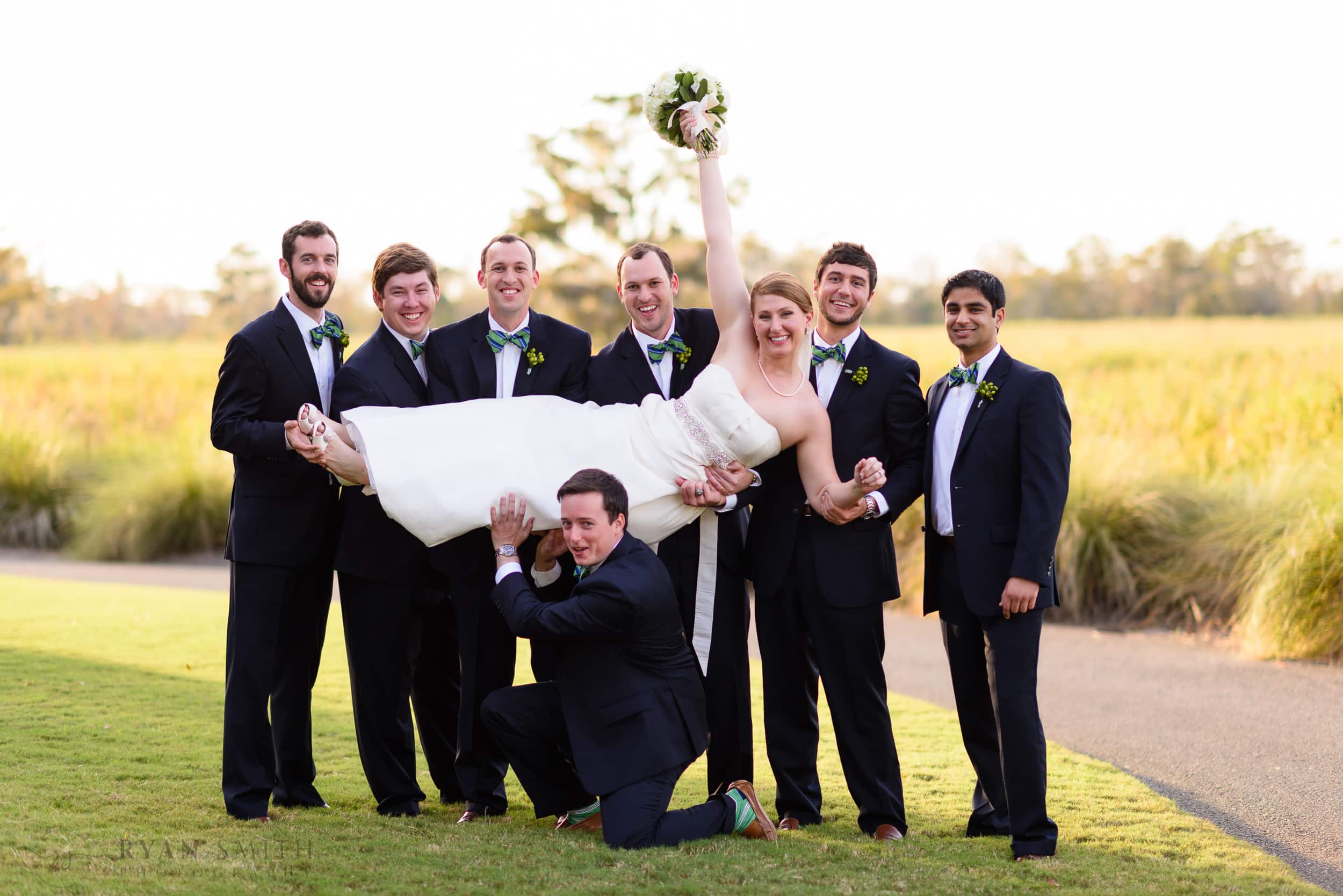 Groomsmen lifting bride into the air - Heritage Golf Club