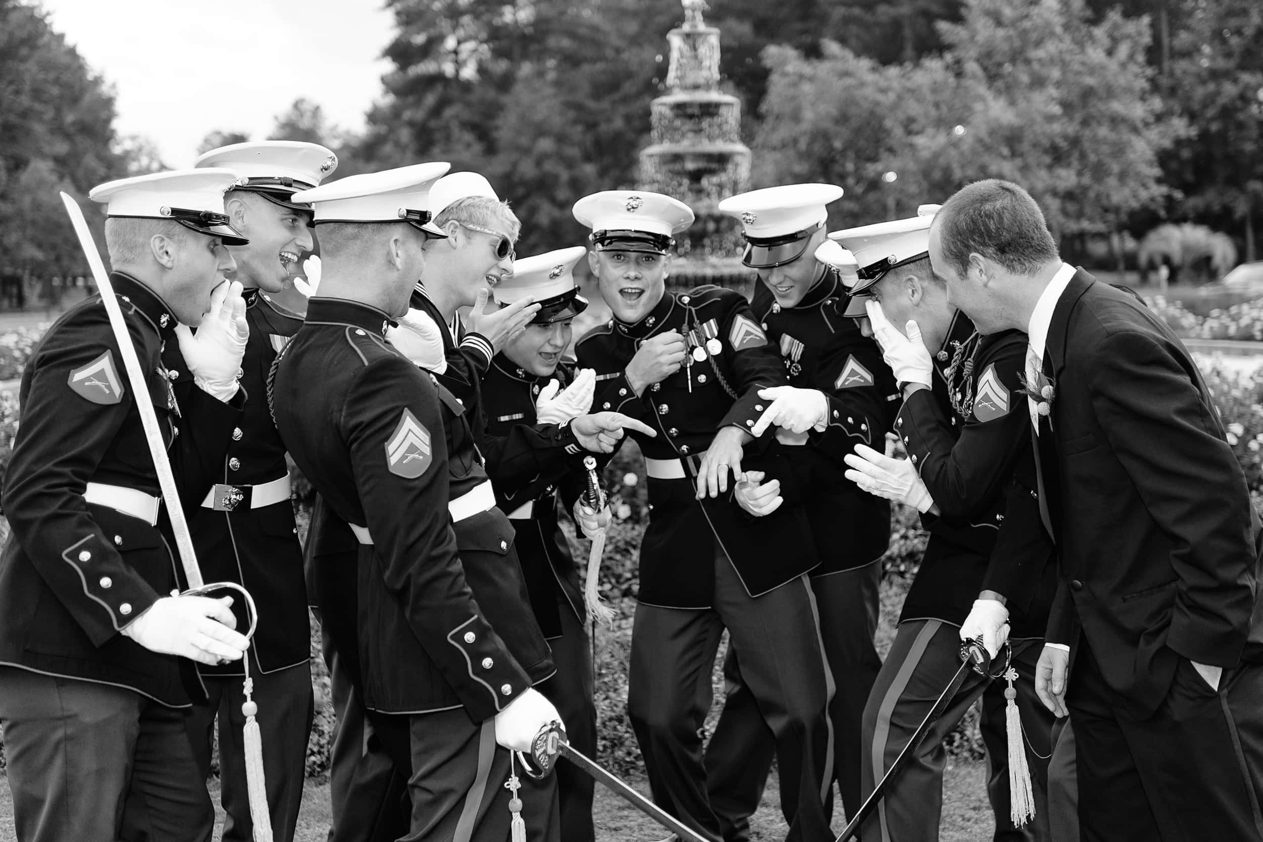 Groomsmen pretending to be excited about ring in military uniforms -