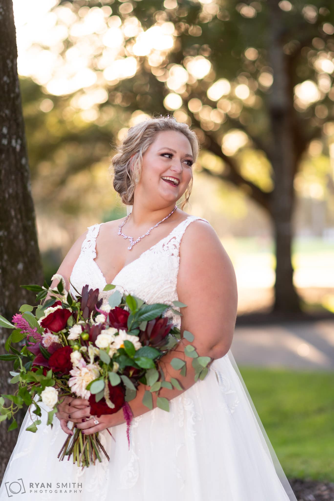 Happy bride looking away from the camera Pawleys Plantation Golf & Country Club