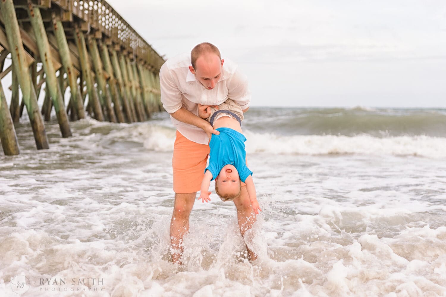 Having fun with his uncle holding him upside down - Myrtle Beach State Park