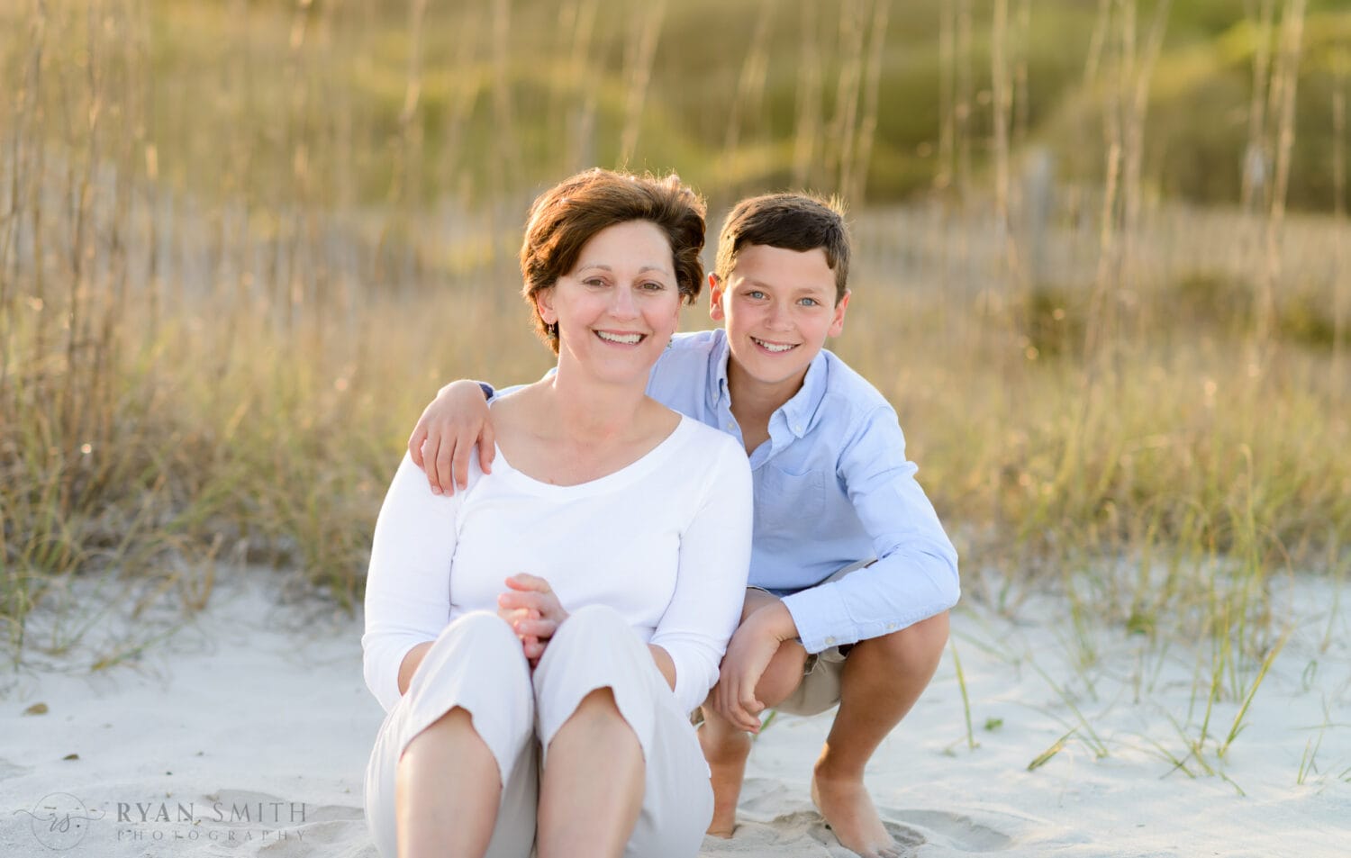 Mom and son sitting in front of the dunes - Myrtle Beach State Park