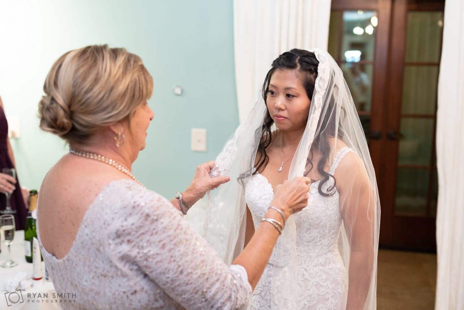 Mom helping bride with her veil 21 Main Events at North Beach
