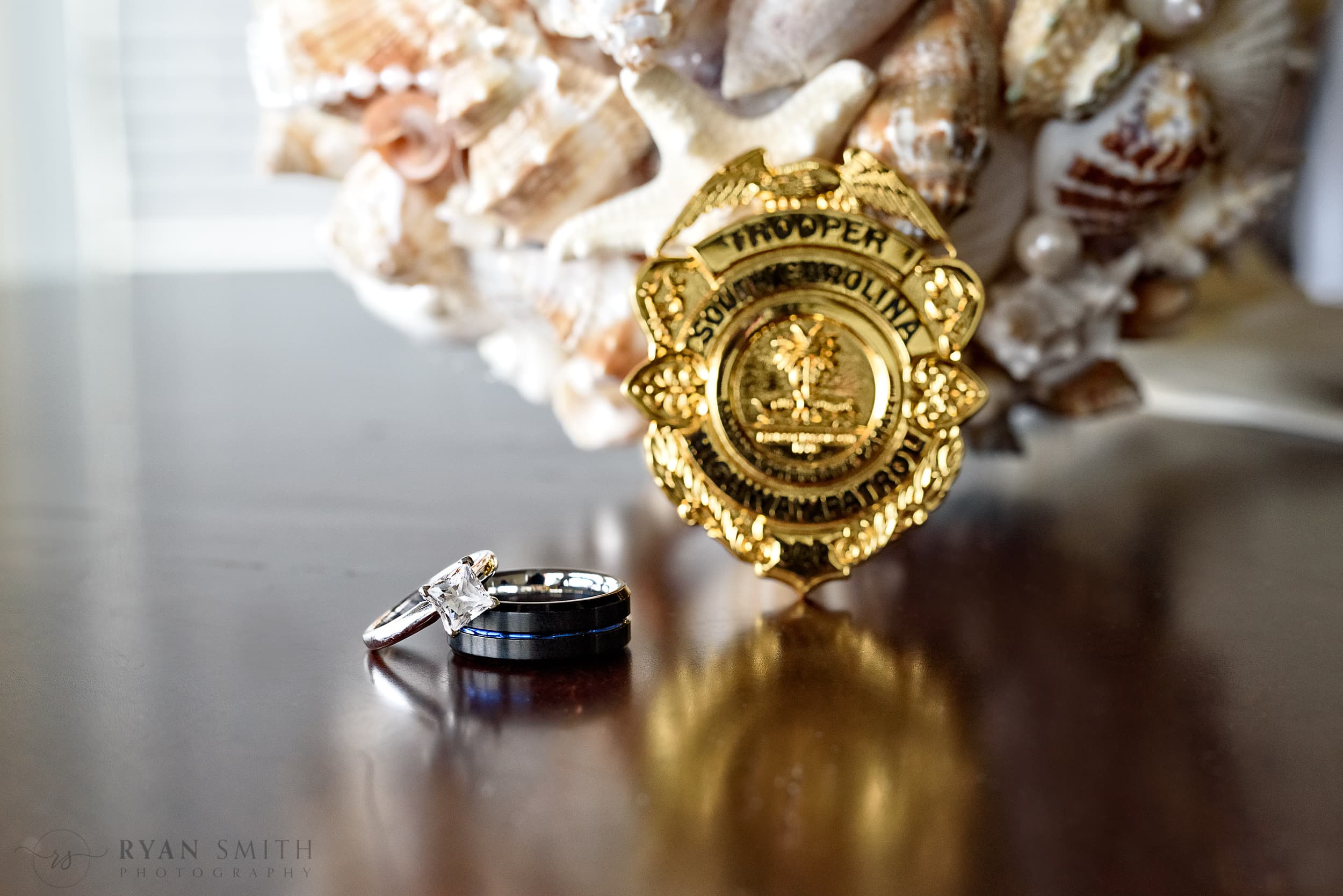 The bride wanted her husband's state trooper badge in the ring shots -