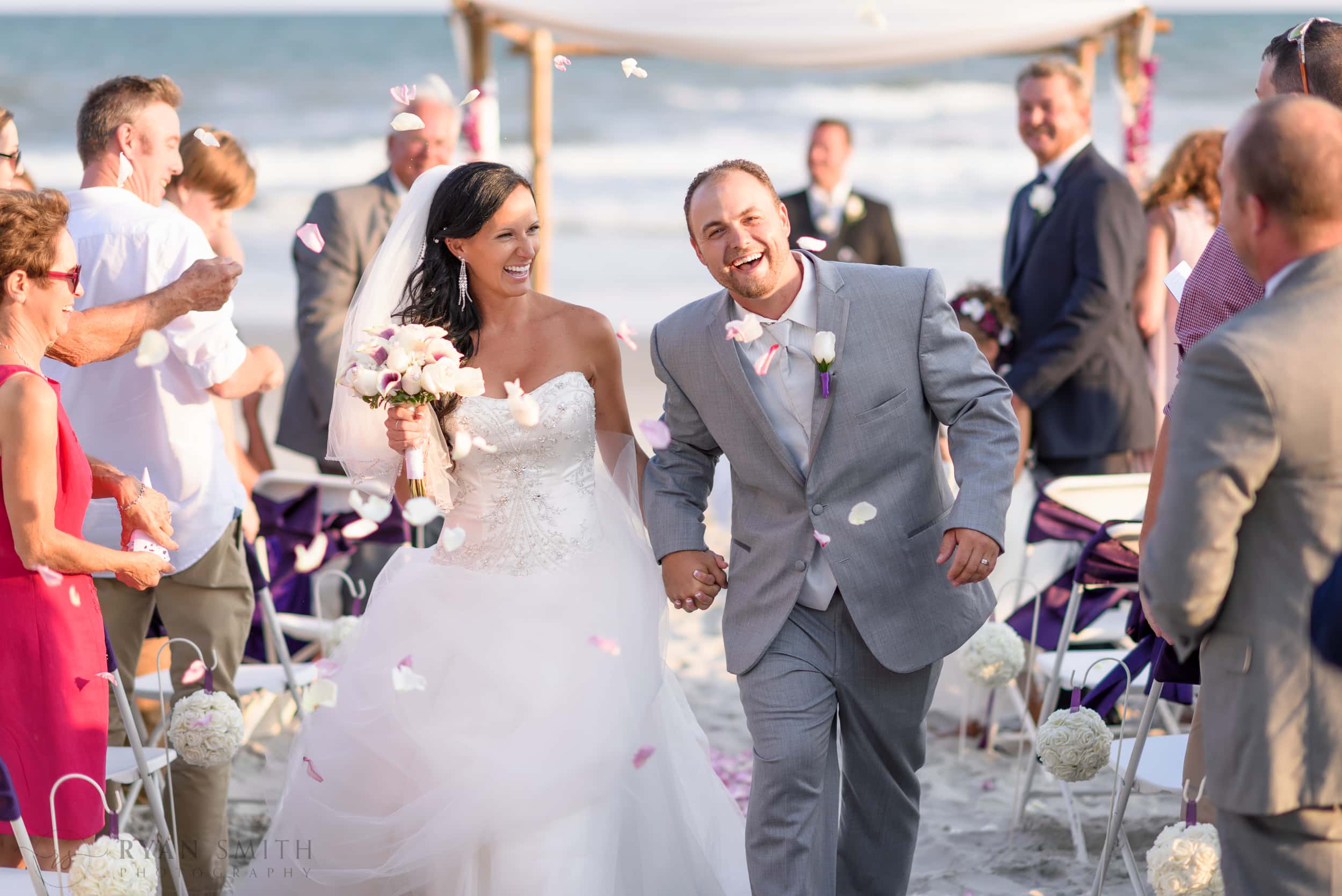 Throwing flower petals around a happy couple after ceremony - Myrtle Beach