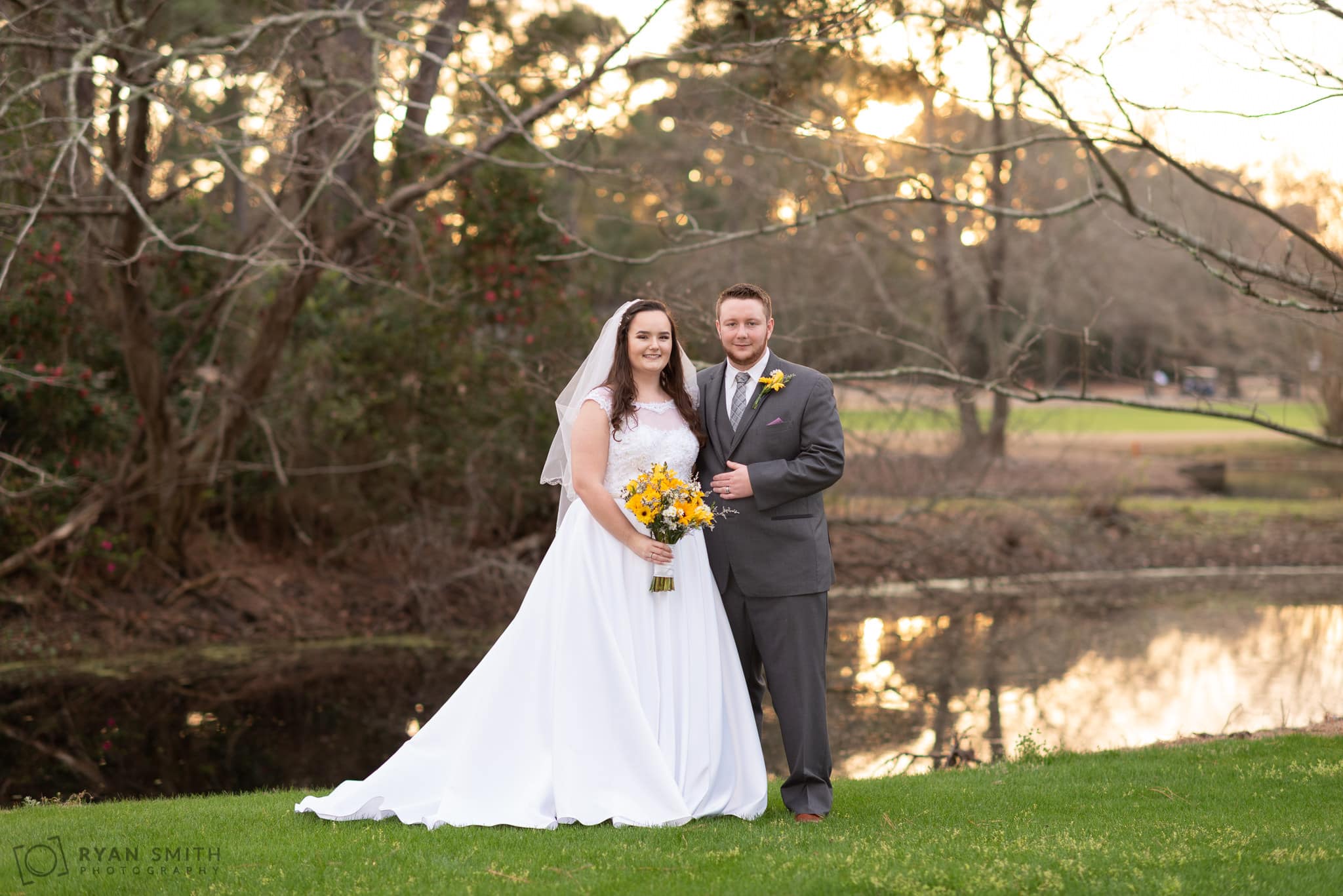 Bride and groom by the pond at sunset Litchfield Country Club
