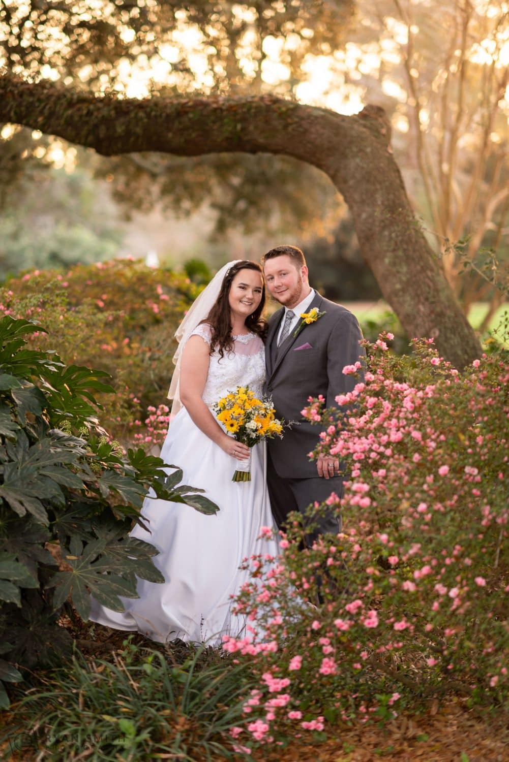 Bride and groom standing in the flowers Litchfield Country Club