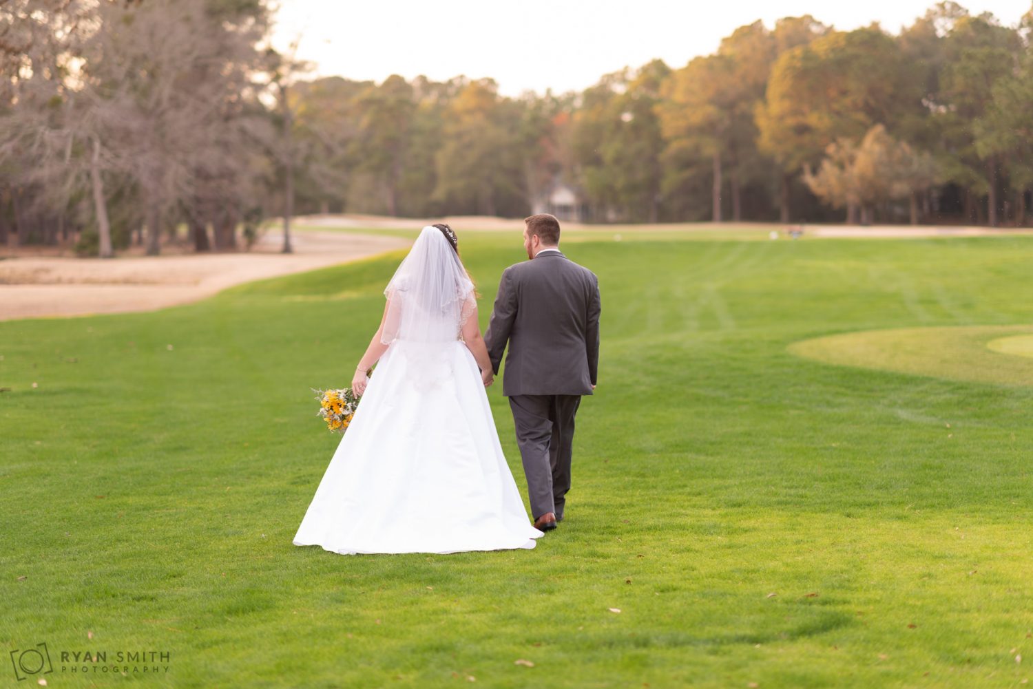 Bride and groom walking down the golf course Litchfield Country Club