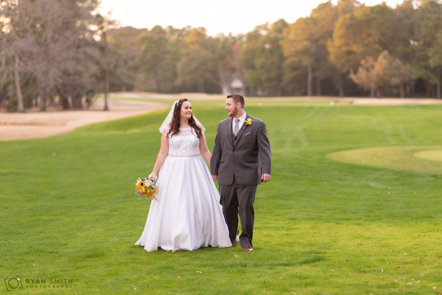 Bride and groom walking down the golf course Litchfield Country Club