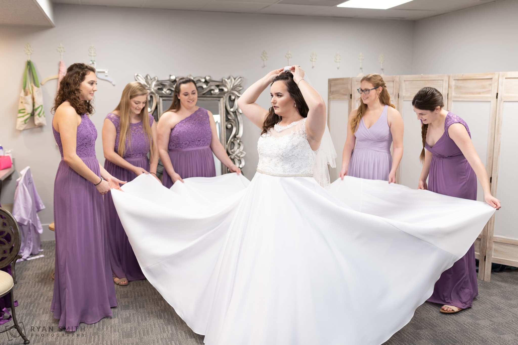 Bridemaids helping bride with her dress Litchfield Country Club