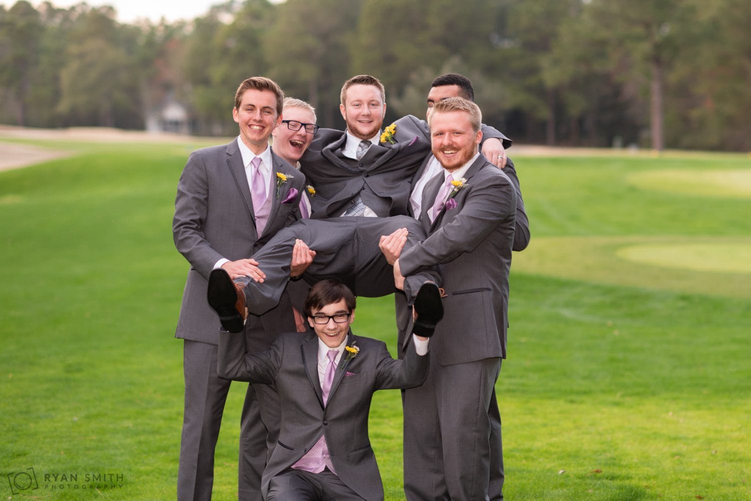 Groomsmen lifting up the groom Litchfield Country Club
