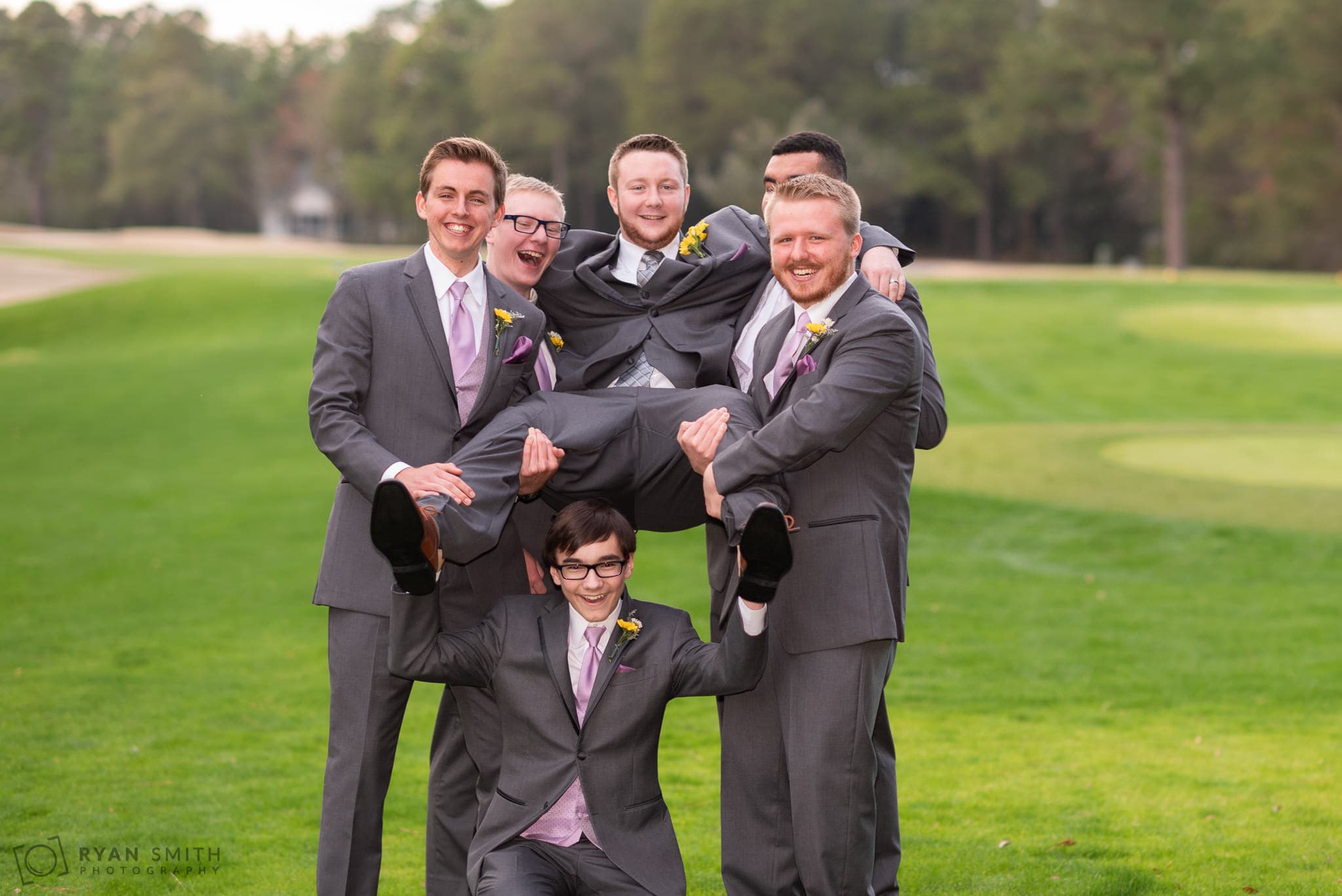 Groomsmen lifting up the groom Litchfield Country Club