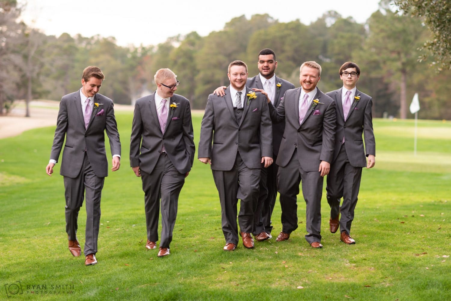 Groomsmen walking together on the golf course Litchfield Country Club