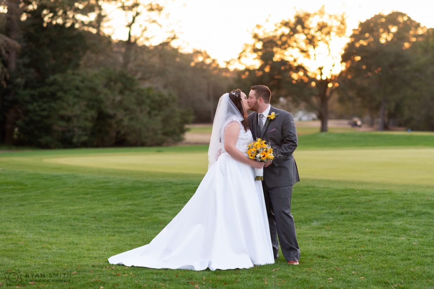 Kiss on the golf course backlit by the sunset Litchfield Country Club