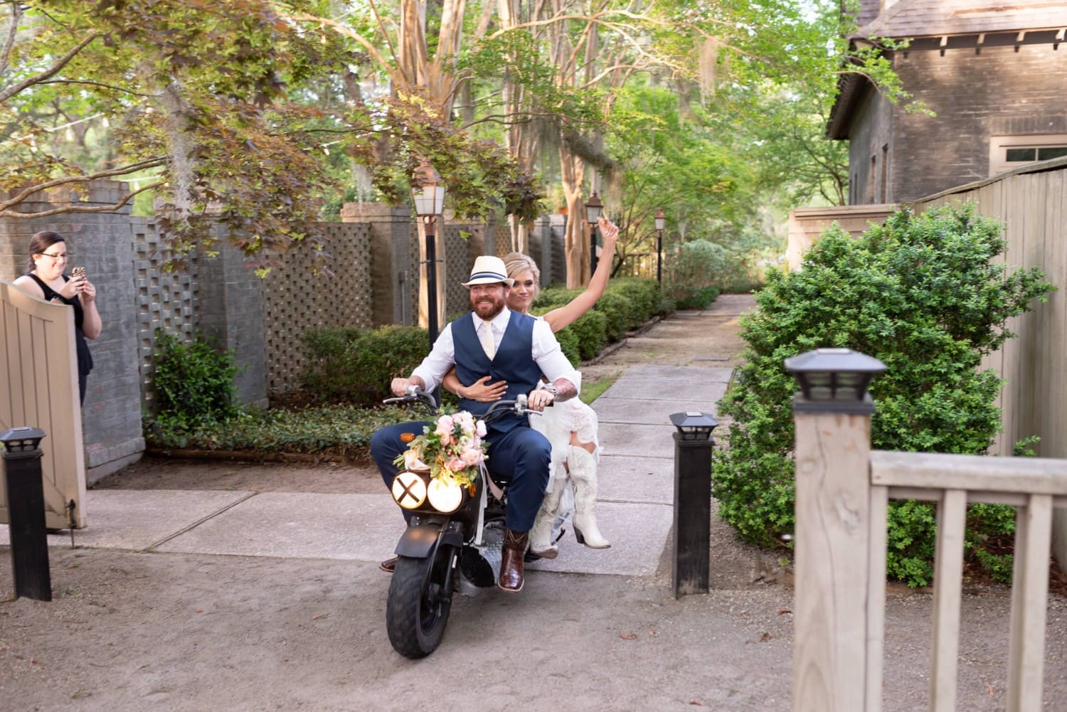 Bride and groom riding in on a scooter - Brookgreen Gardens
