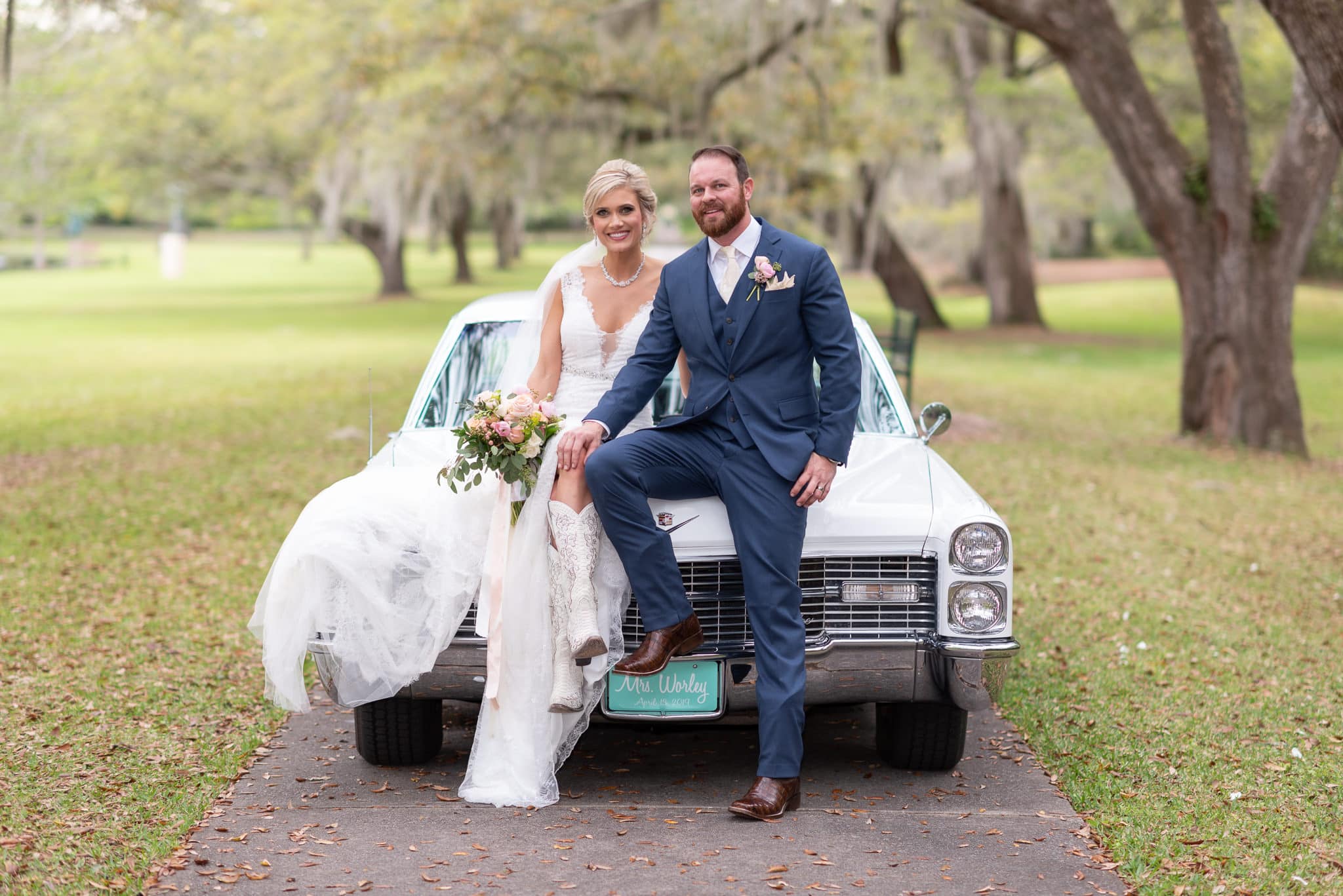 Bride and groom sitting on the classic car - Brookgreen Gardens