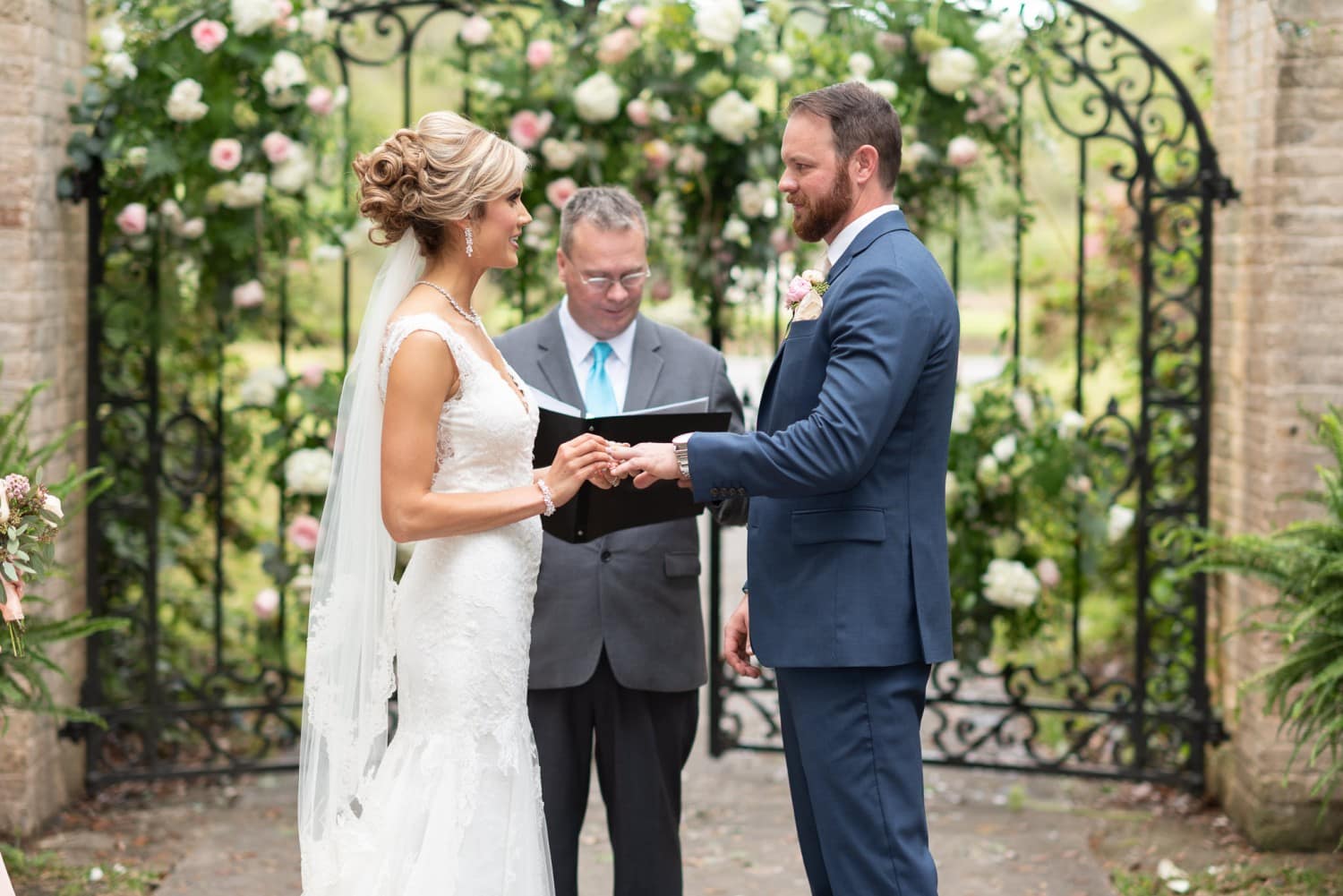 Bride putting ring on groom - Brookgreen Gardens