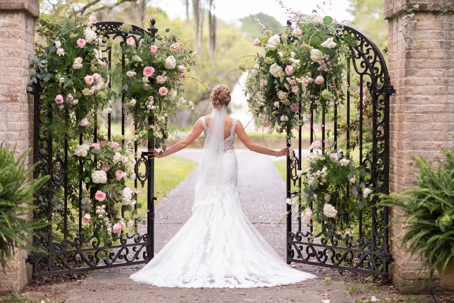 Bride walking through the garden gates - Brookgreen Gardens
