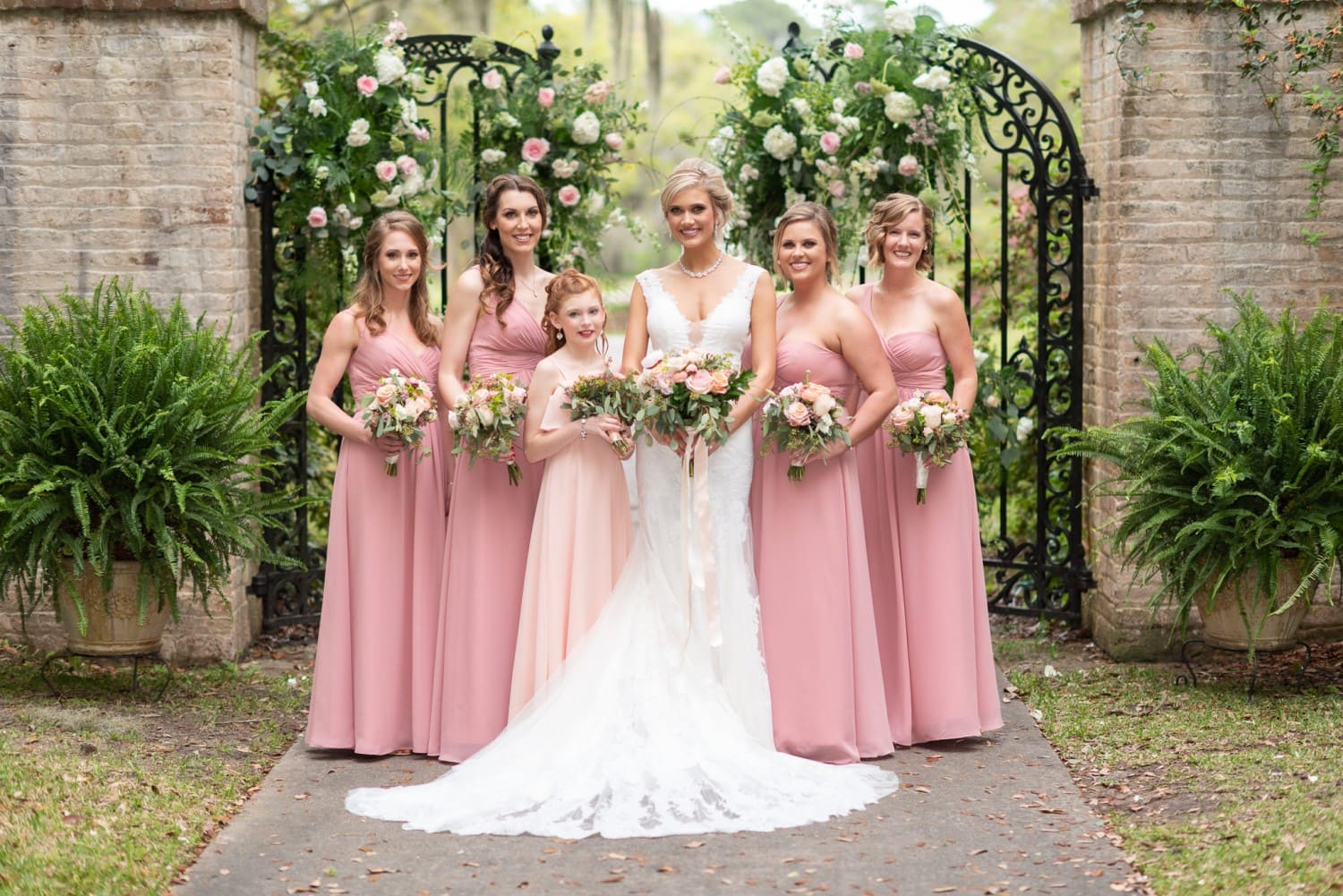 Bridesmaids and bride standing by the gates - Brookgreen Gardens