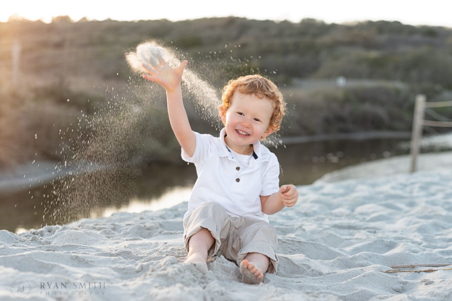 Little boy throwing sand - Myrtle Beach State Park