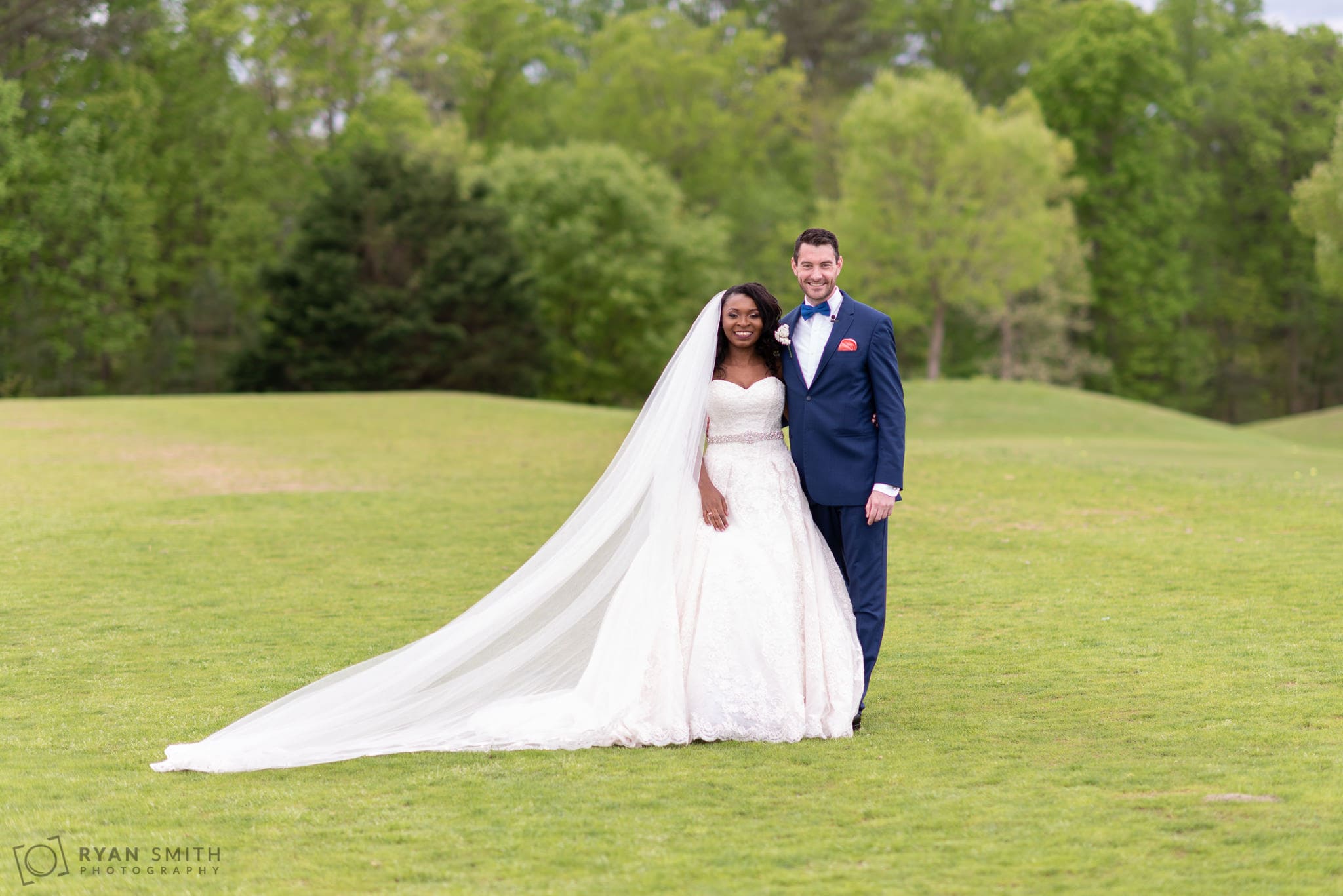 Bride and groom in traditional wedding dress and suit River Ridge Golf Club