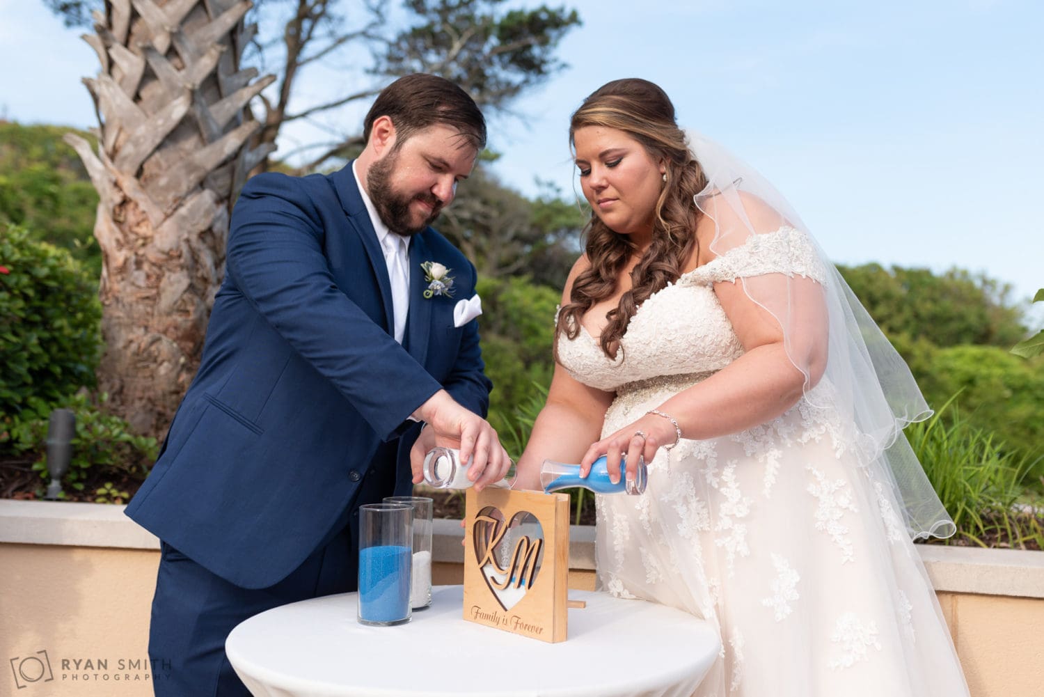 Bride and groom pouring sand together Grande Dunes Ocean Club