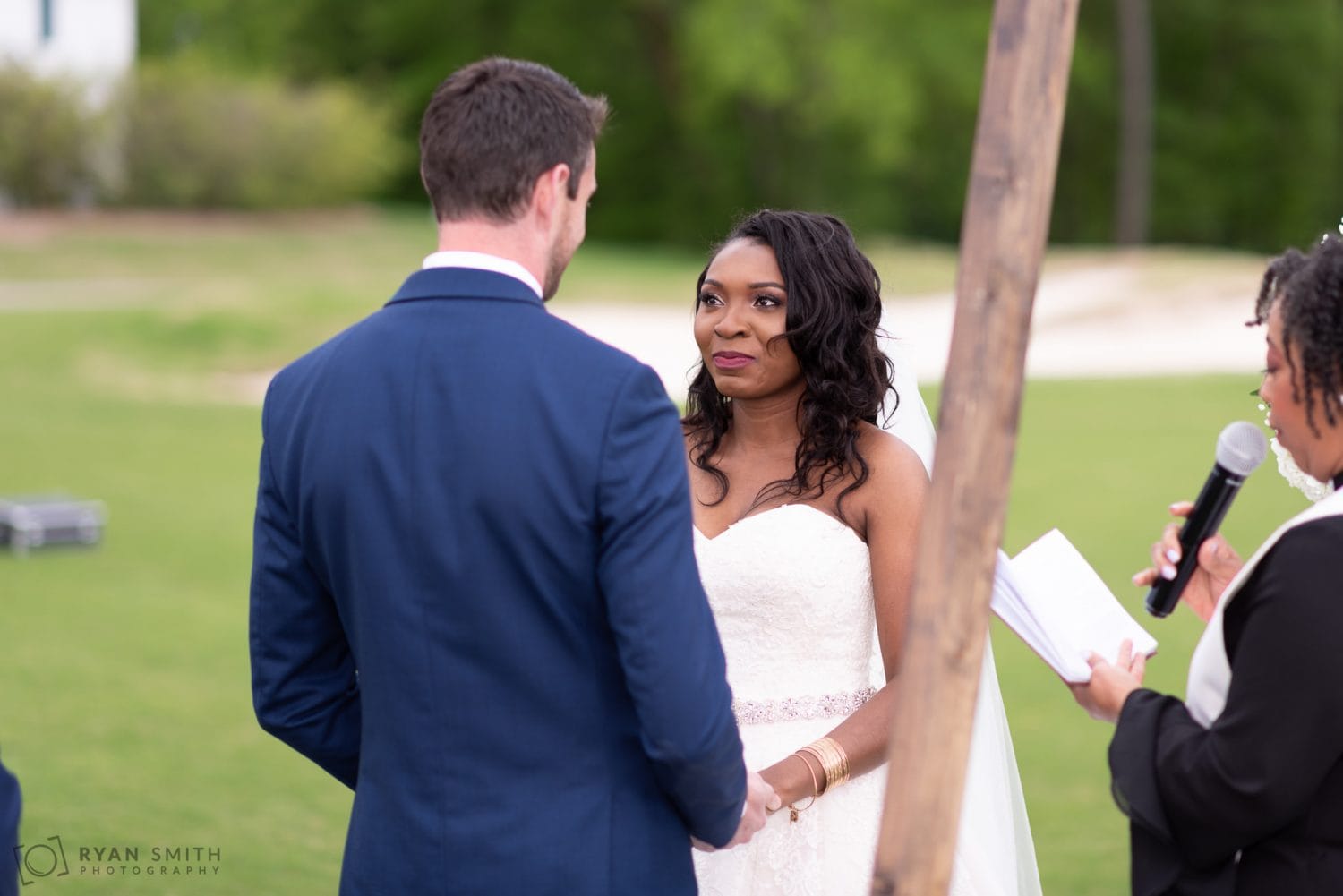 Bride looking into grooms eyes during the ceremony River Ridge Golf Club