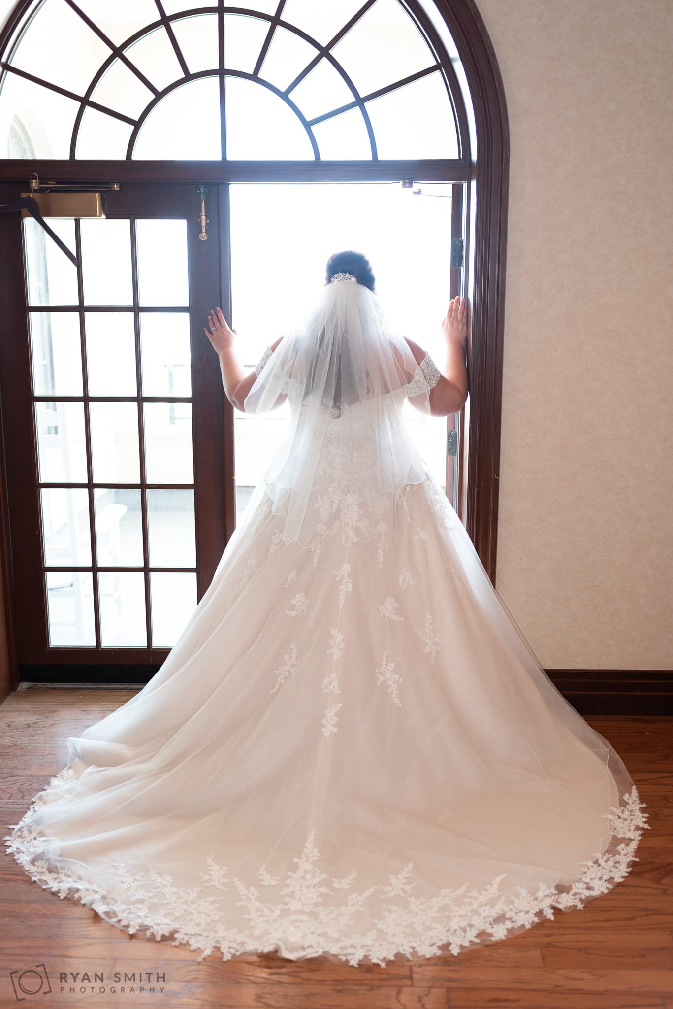 Bride standing in the doorway light Grande Dunes Ocean Club