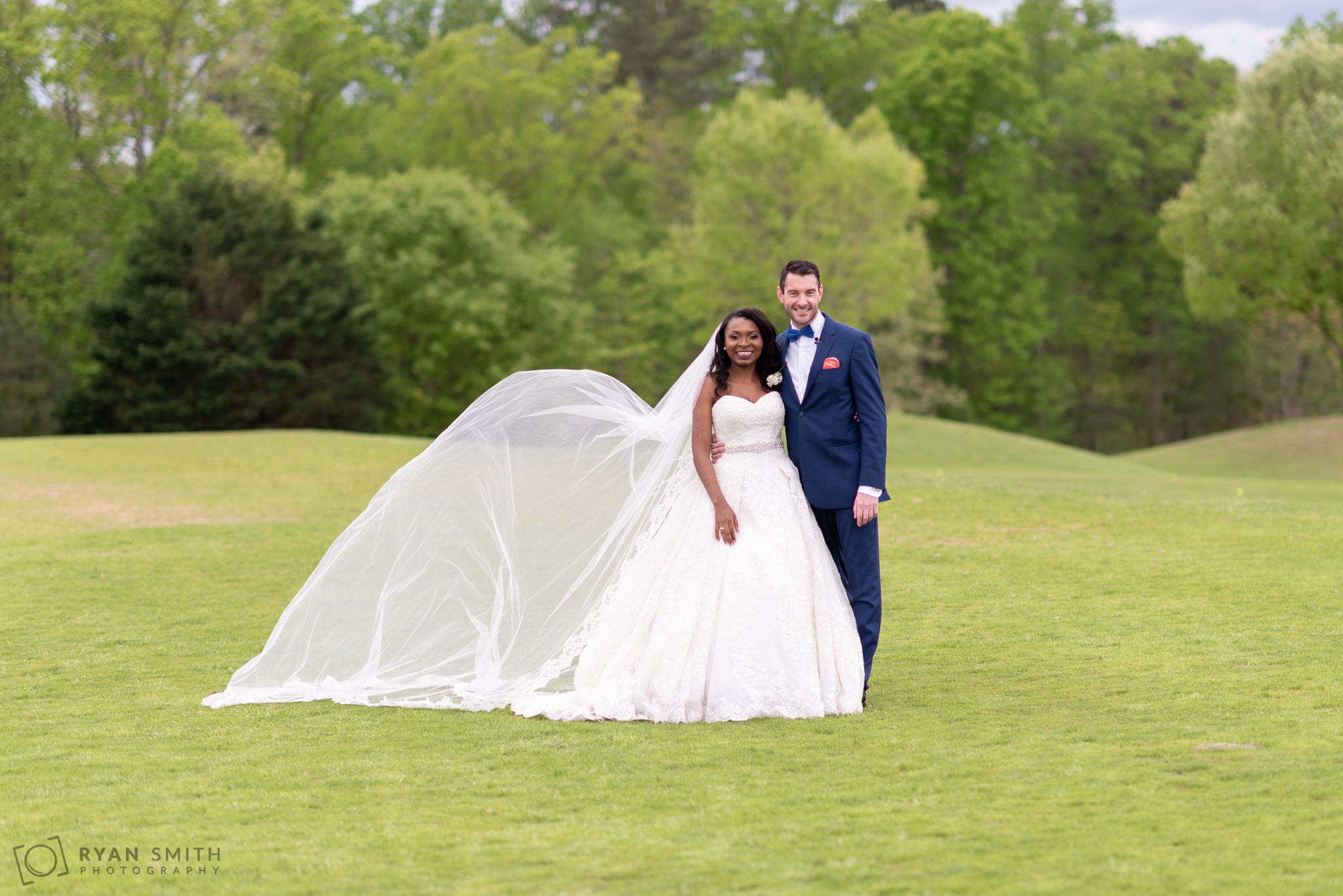 Bride with veil blowing River Ridge Golf Club