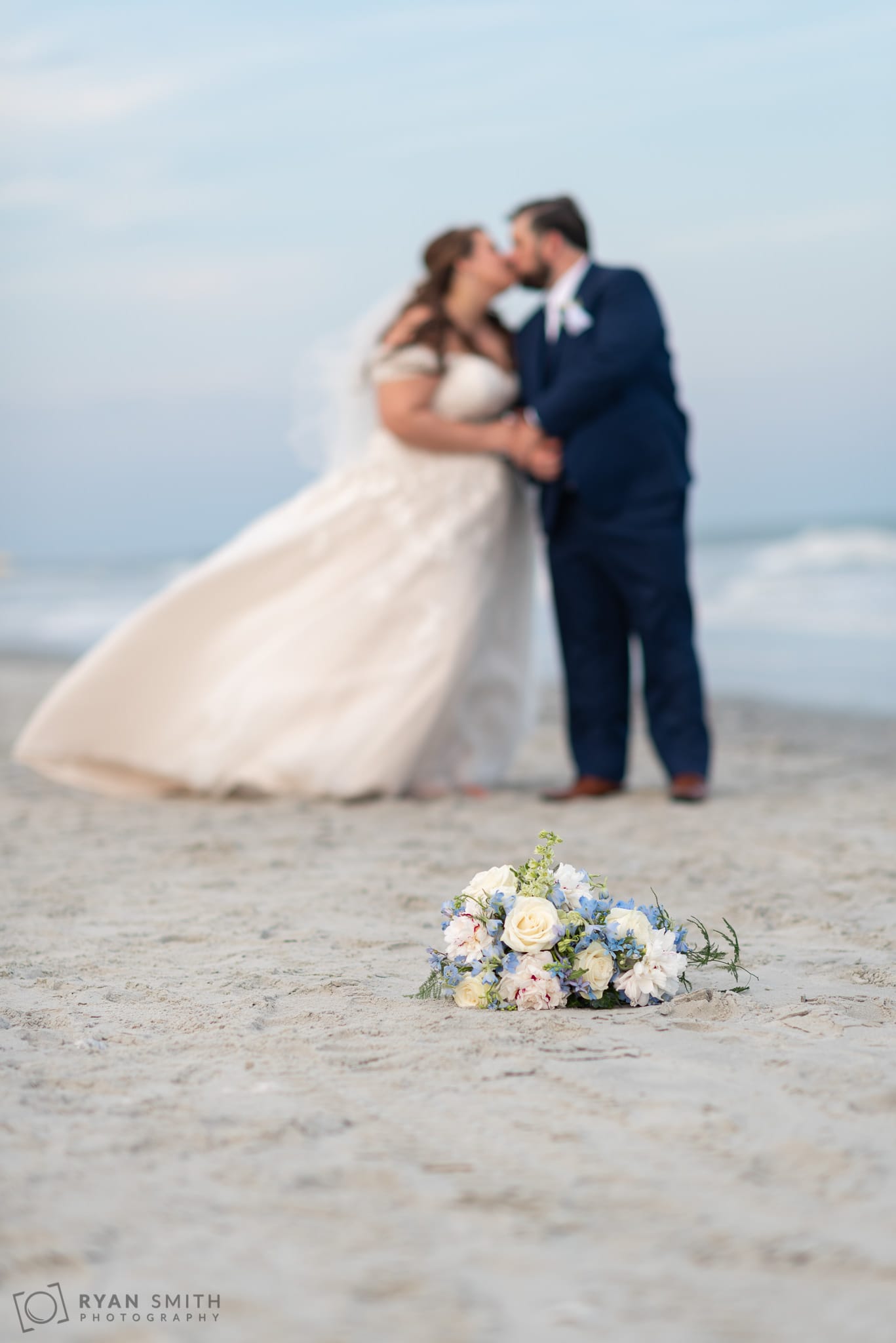 Flowers in focus with couple kissing in the background Grande Dunes Ocean Club