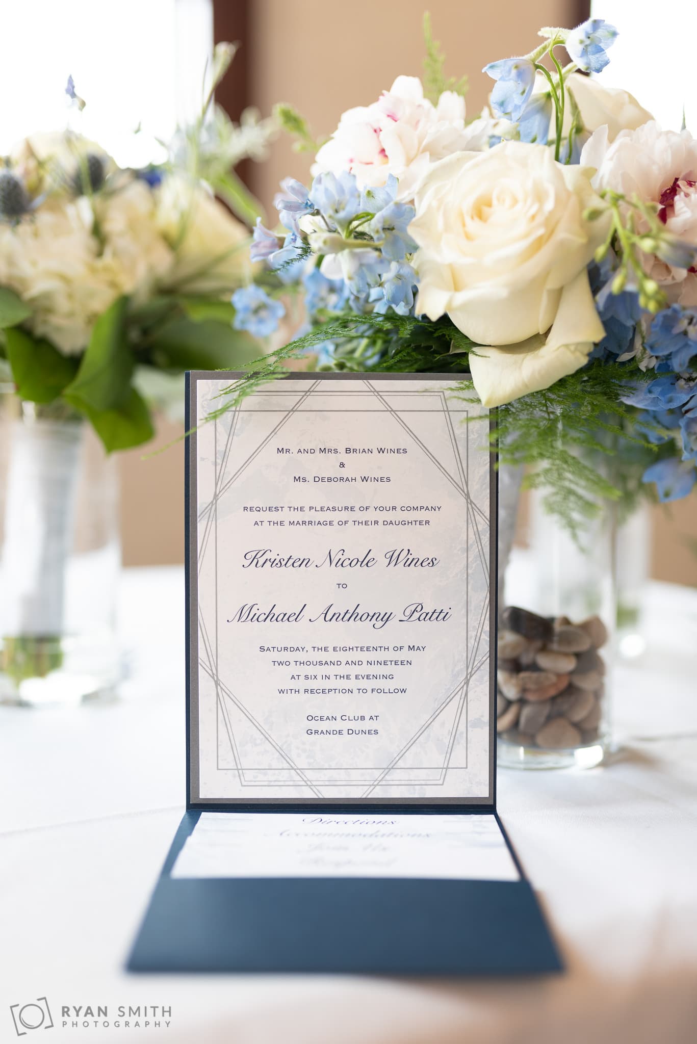 Wedding invitation against the flowers Grande Dunes Ocean Club