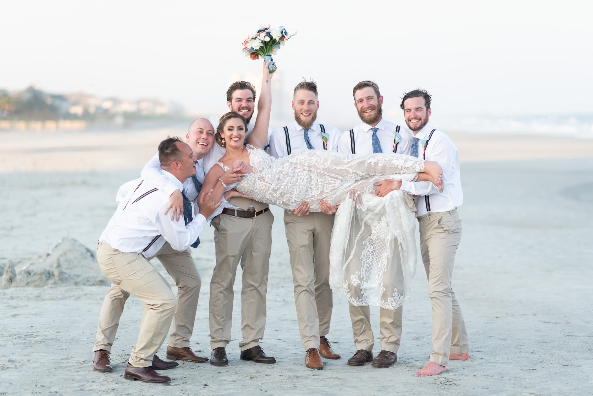 Groomsmen lifting up the bride Grande Dunes Ocean Club - Myrtle Beach