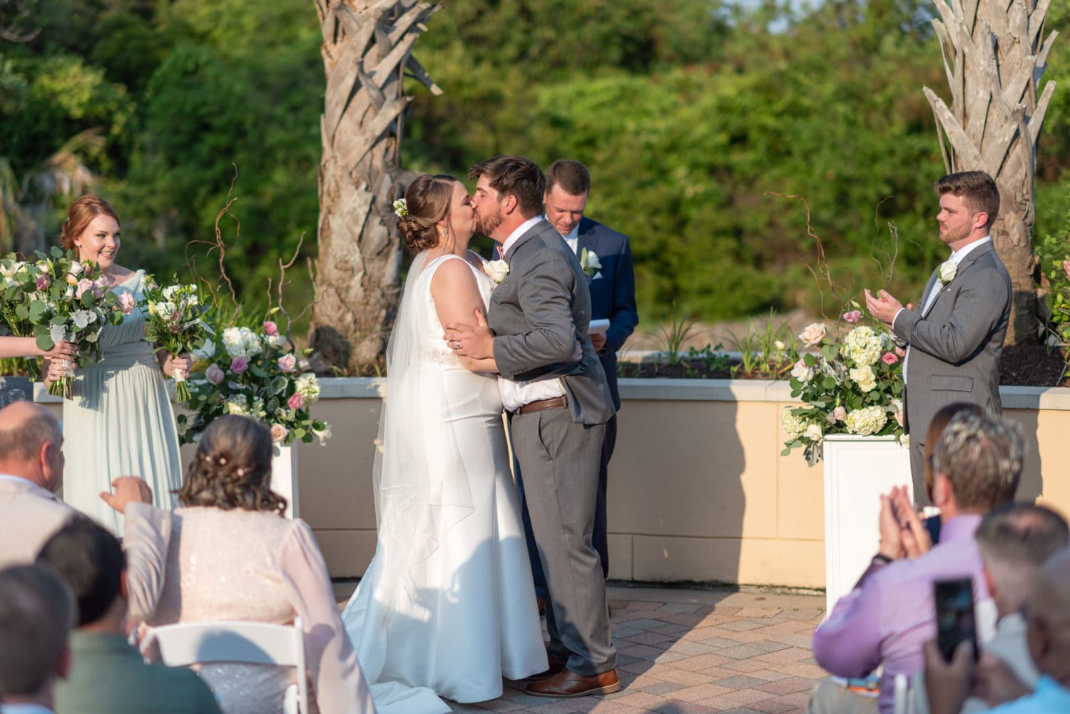 Wedding ceremony by the palm trees on the patio - Grande Dunes Ocean Club - Myrtle Beach