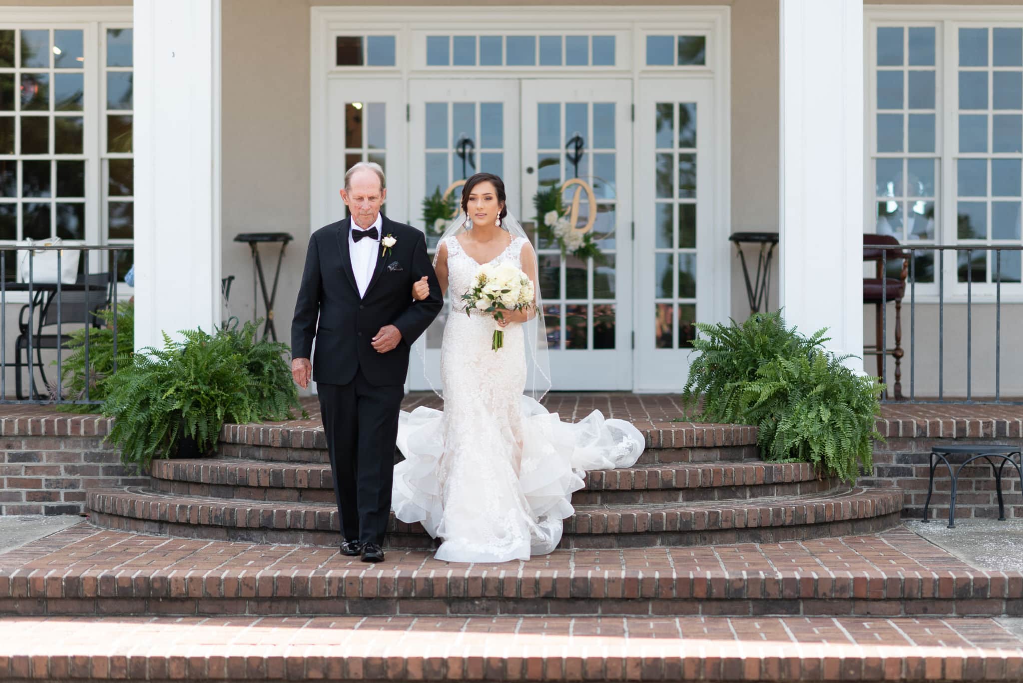 Bride and father walking down the steps Pawleys Plantation
