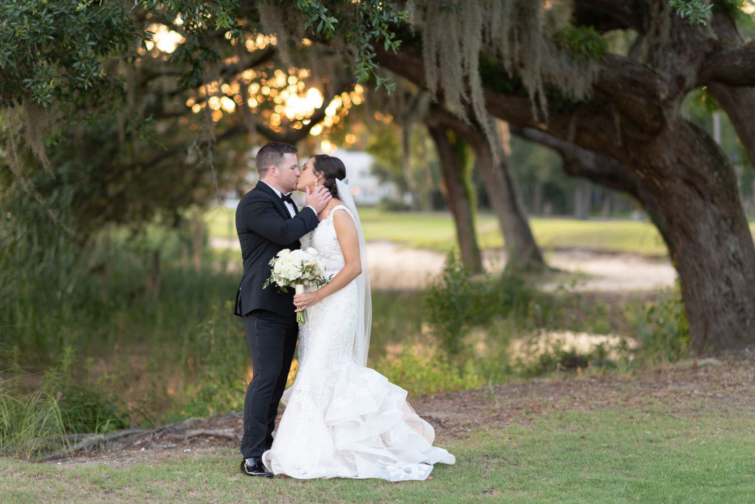 Groom pulling bride in for a kiss Pawleys Plantation