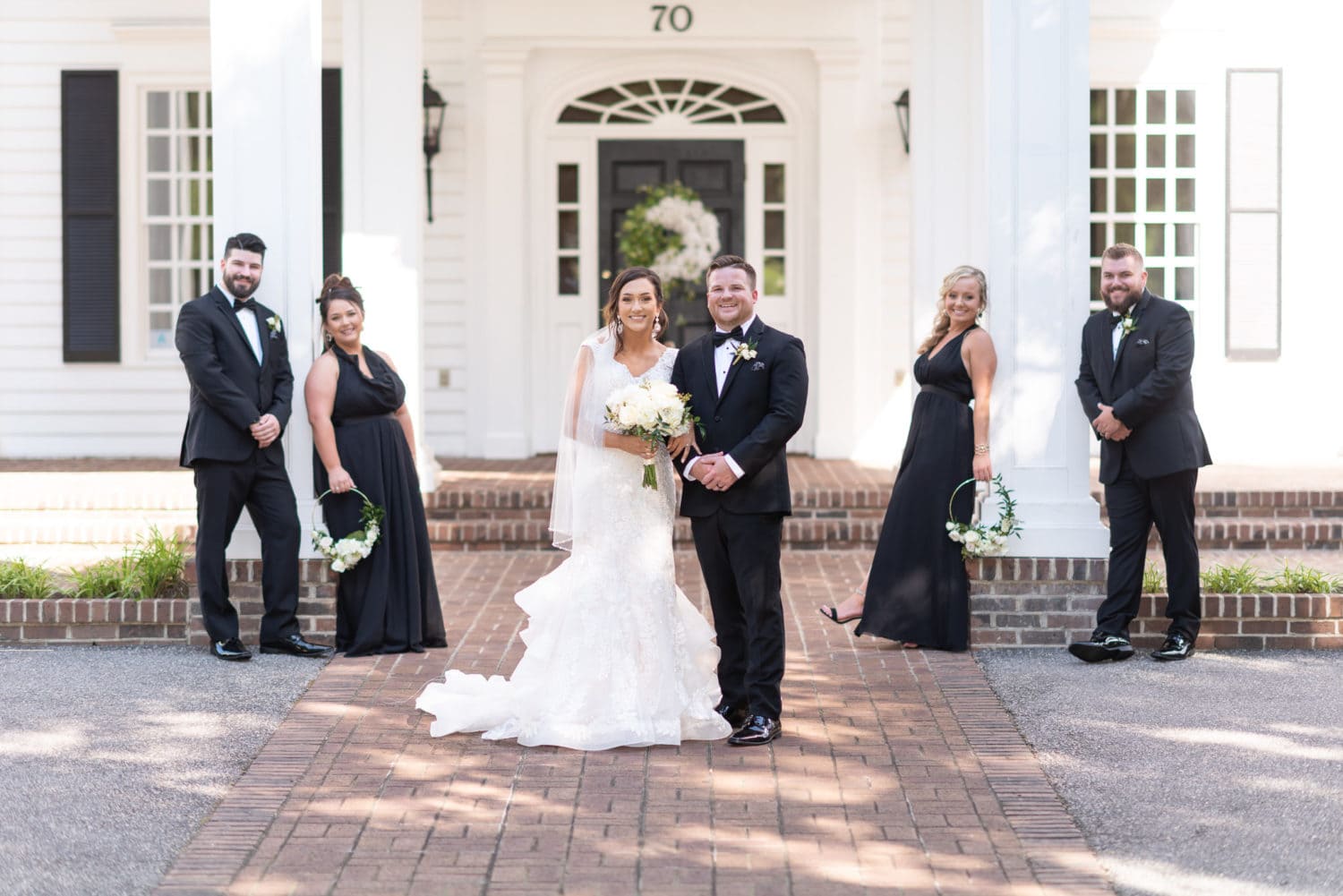 Pose with the wedding party in front of the clubhouse Pawleys Plantation