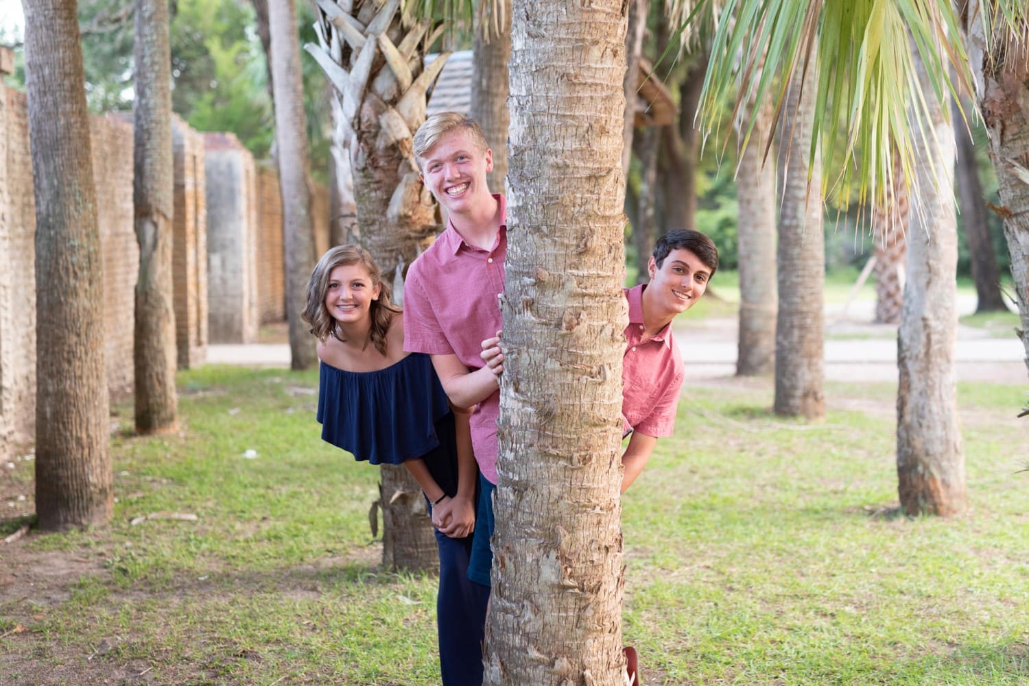 Kids peeking out from behind a tree - Huntington Beach State Park