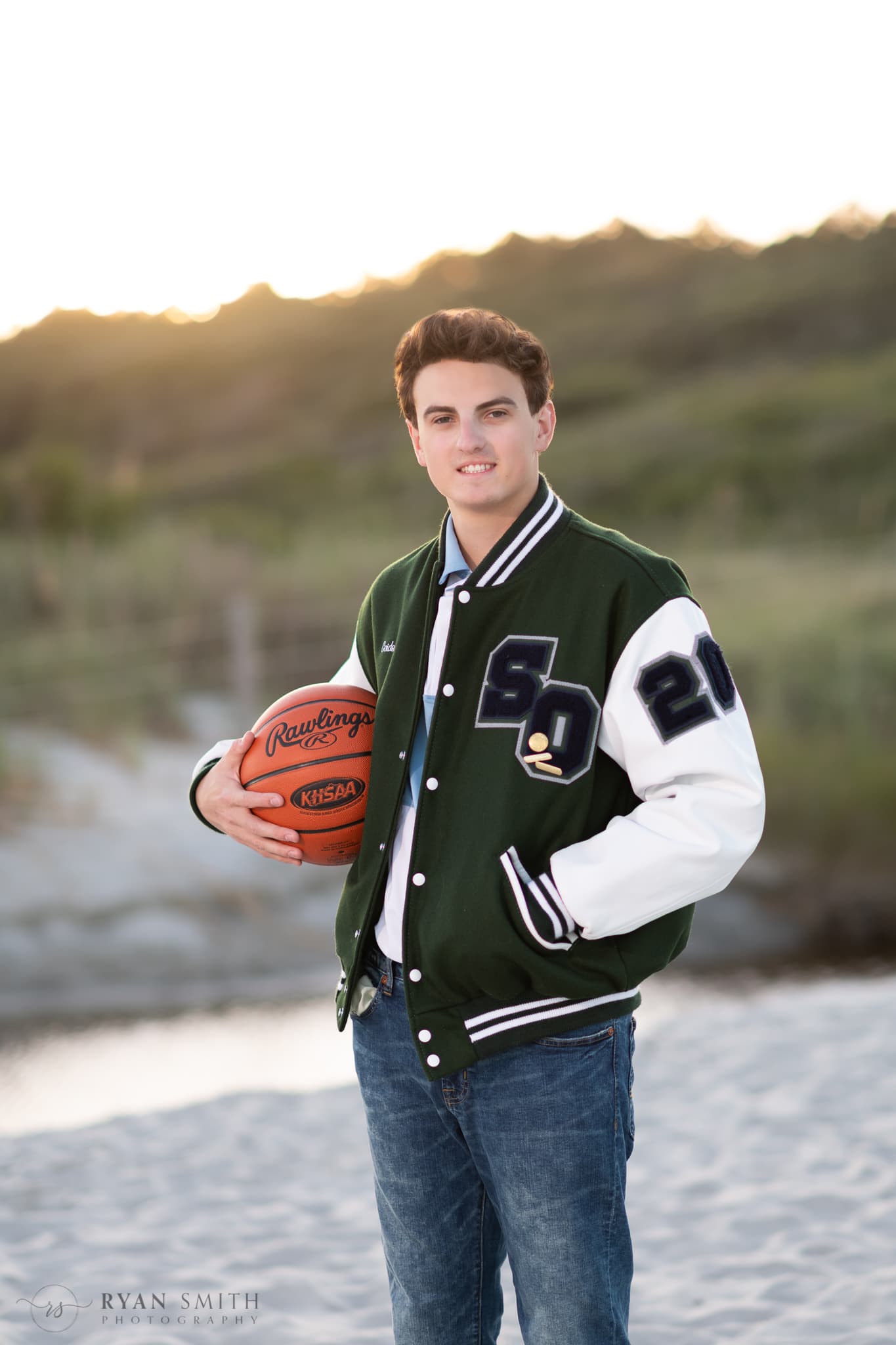 High school senior holding basketball by the dunes - Myrtle Beach State Park