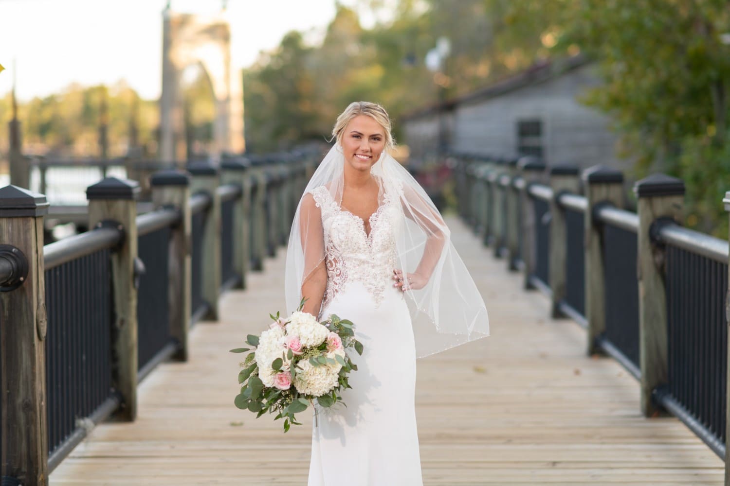 Bride holding bouquet on the boardwalk - Conway River Walk