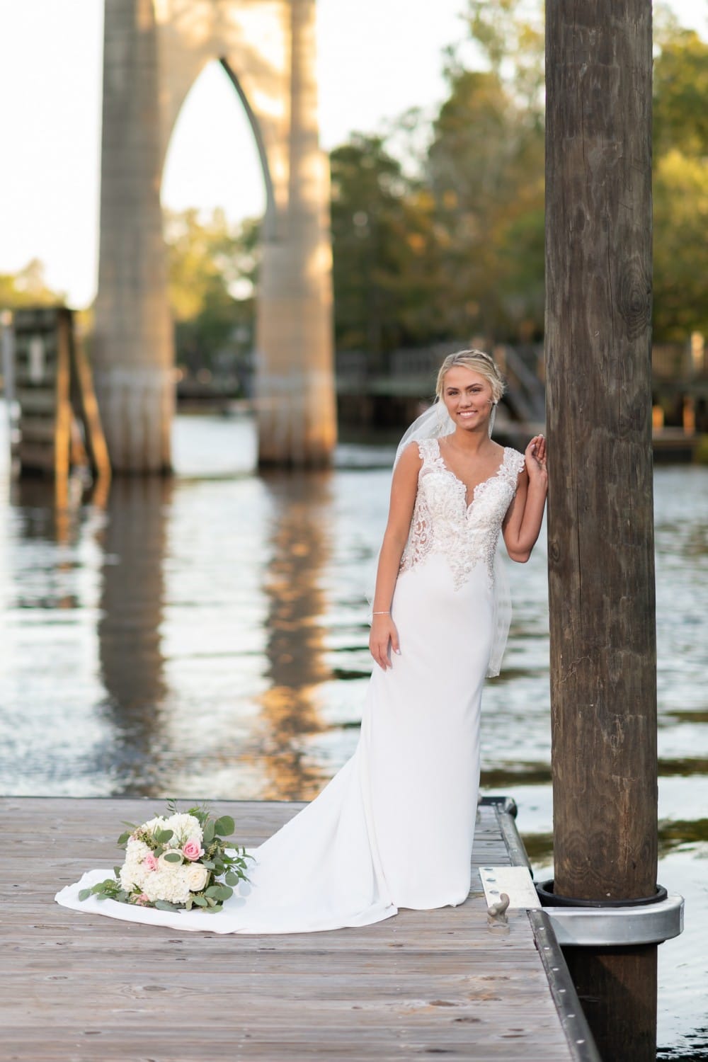 Bride leaning against the dock  - Conway River Walk