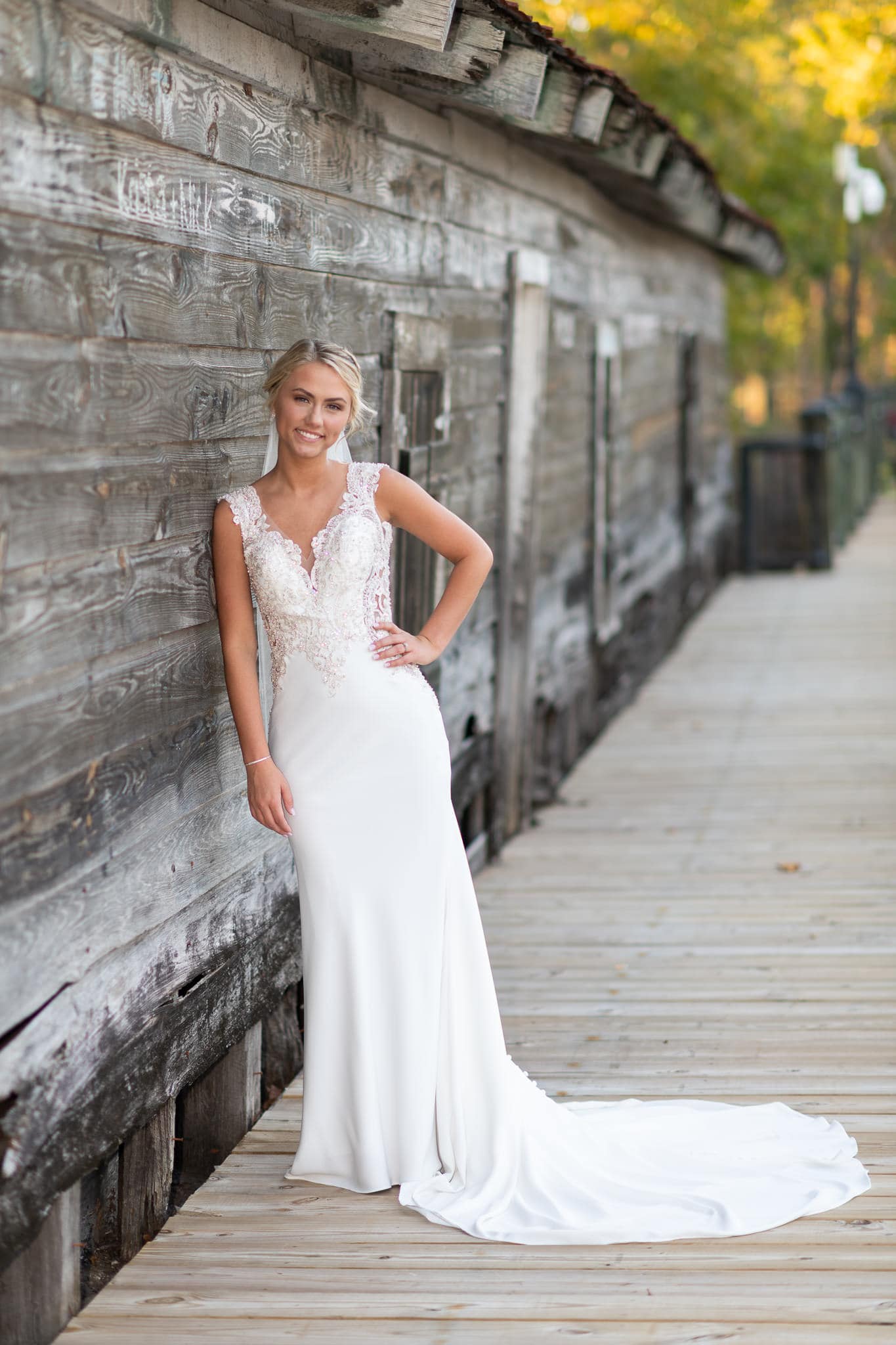 Bride leaning against the old wall - Conway River Walk