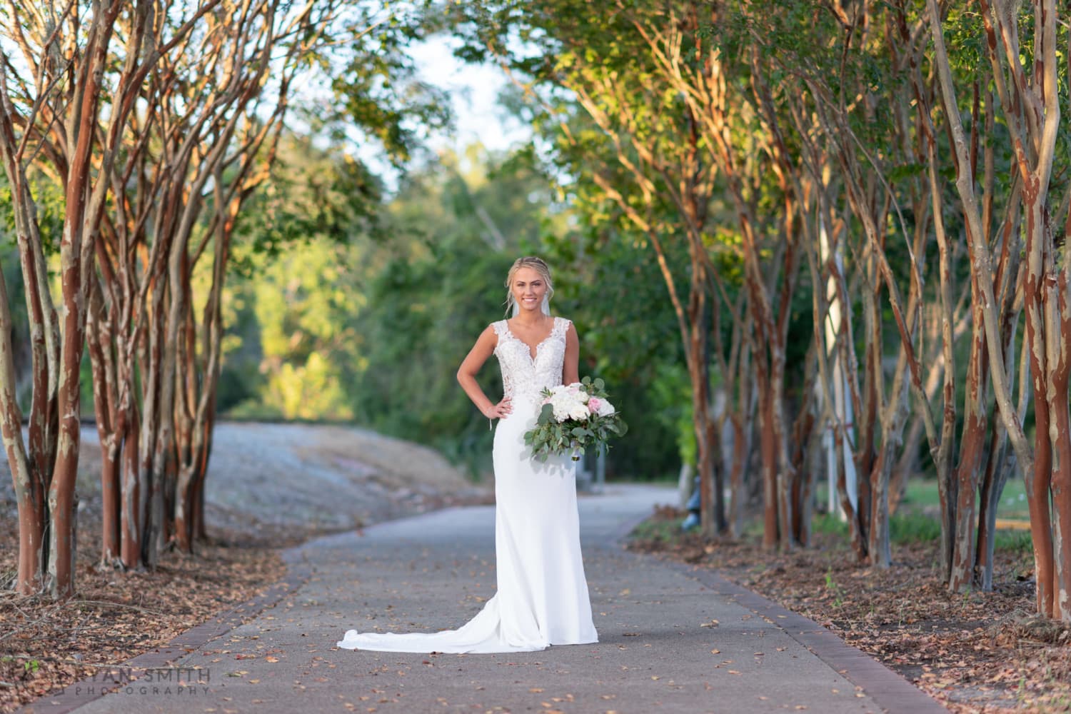 Bride standing on the tree covered walkway - Conway River Walk