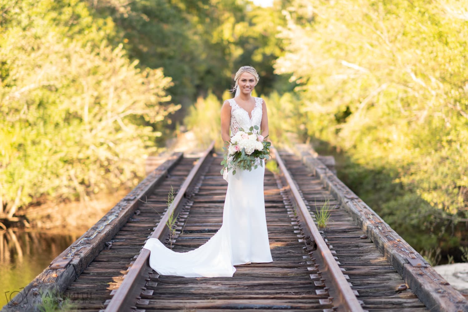 Bride standing on train tracks - Conway River Walk